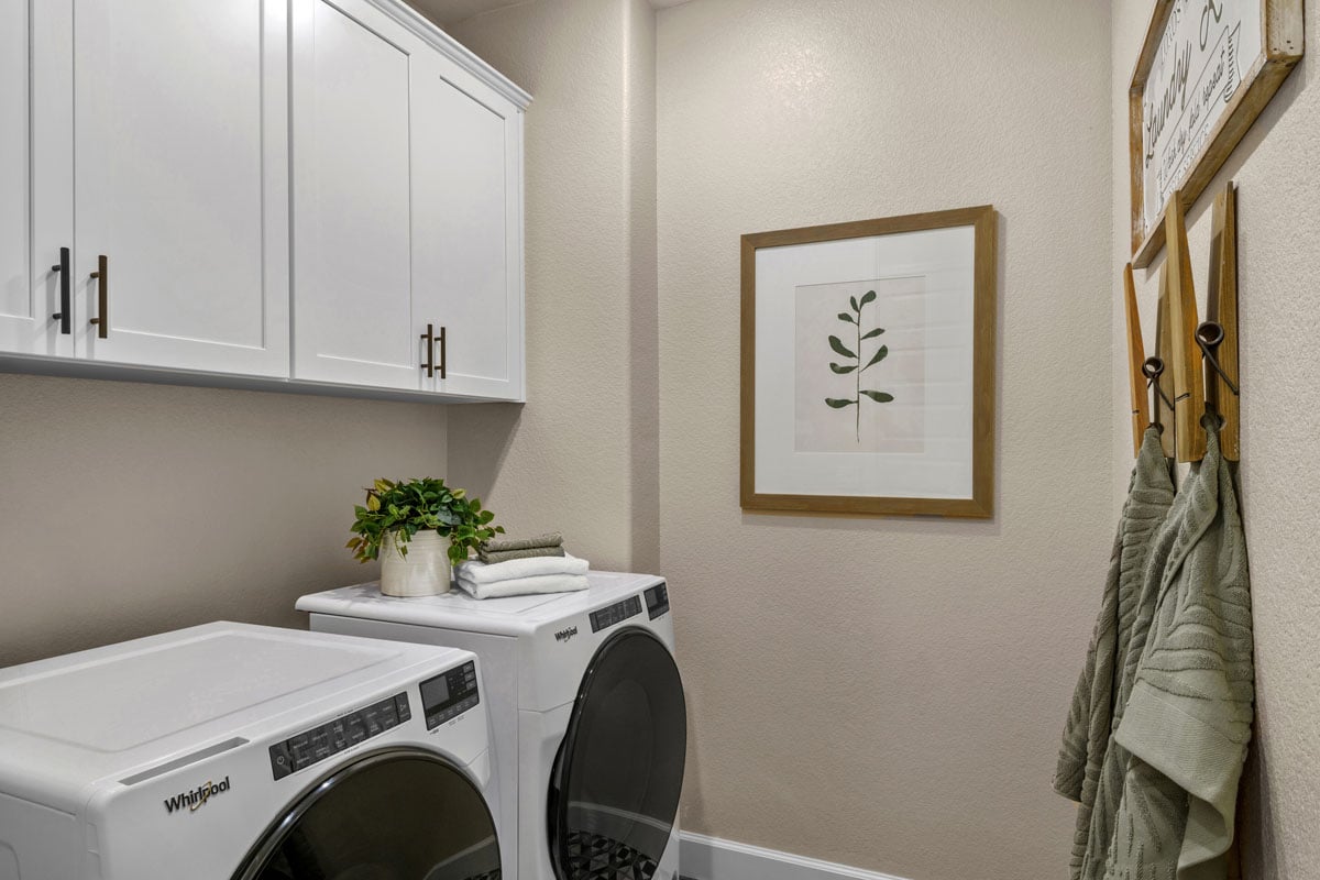 Dedicated laundry room with upper cabinets