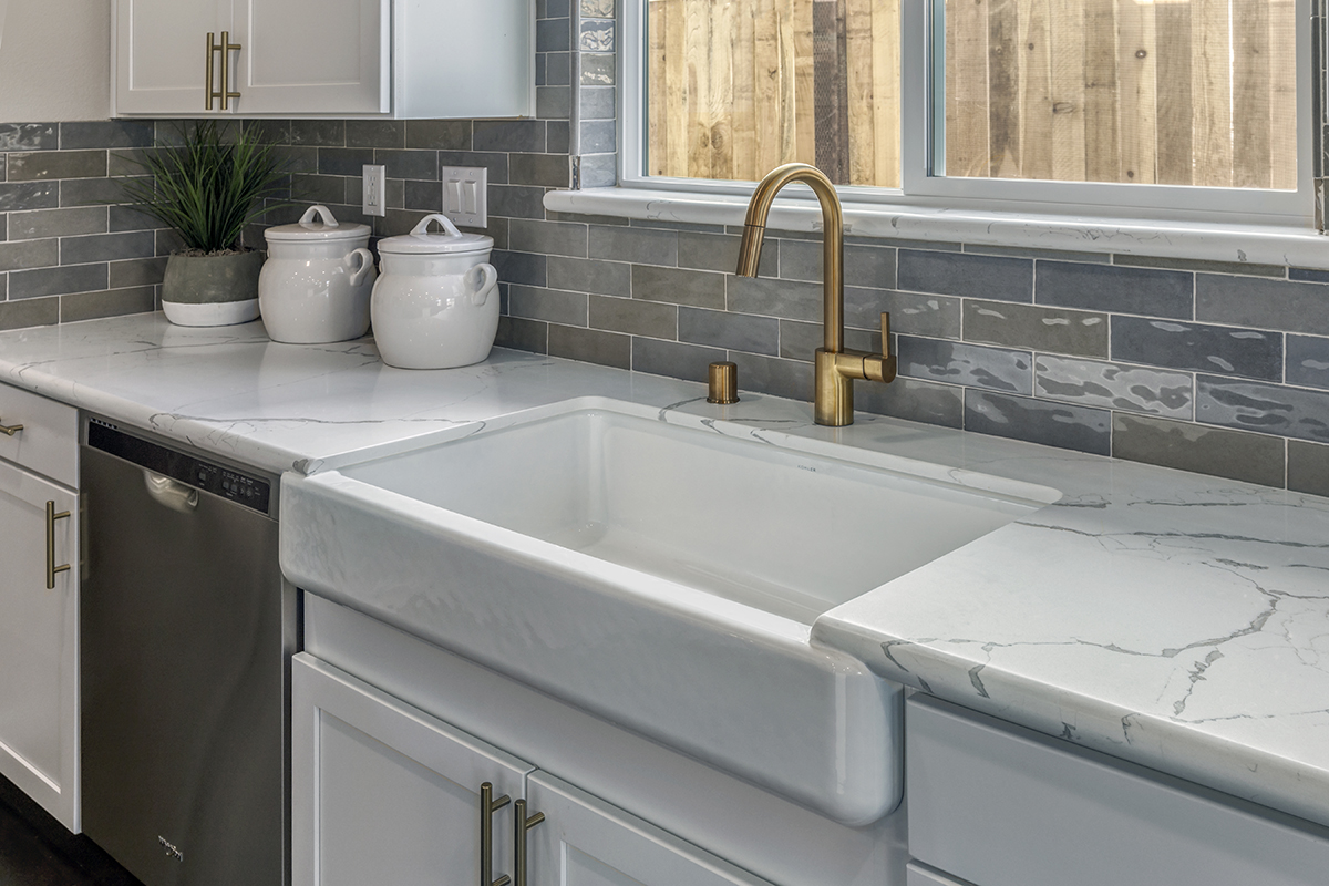 Kitchen with farmhouse sink and faucet