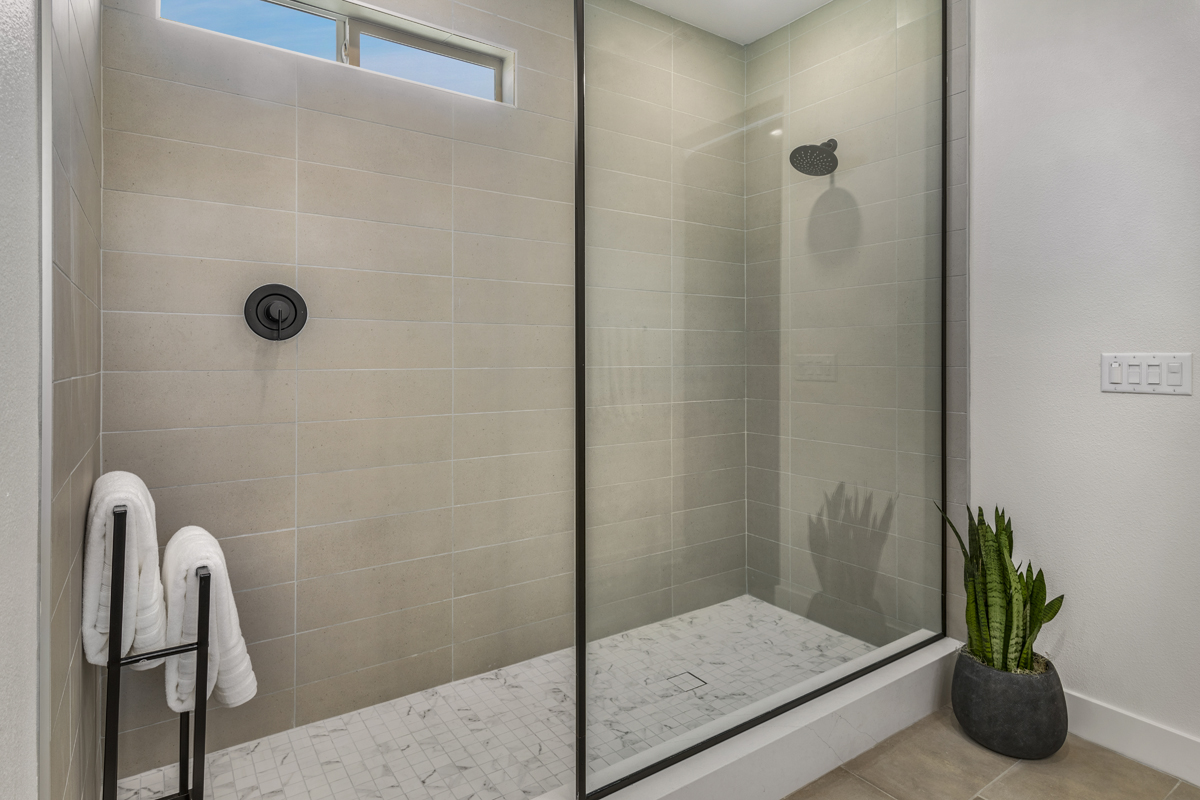 Shower with clear enclosure at primary bath