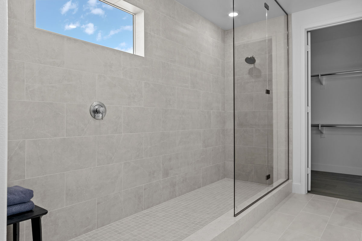 Extended shower with custom tile surround at primary bath