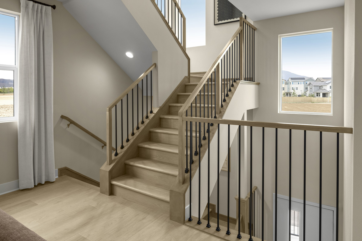 Optional stair rail system with oak-stained wood posts and iron balusters