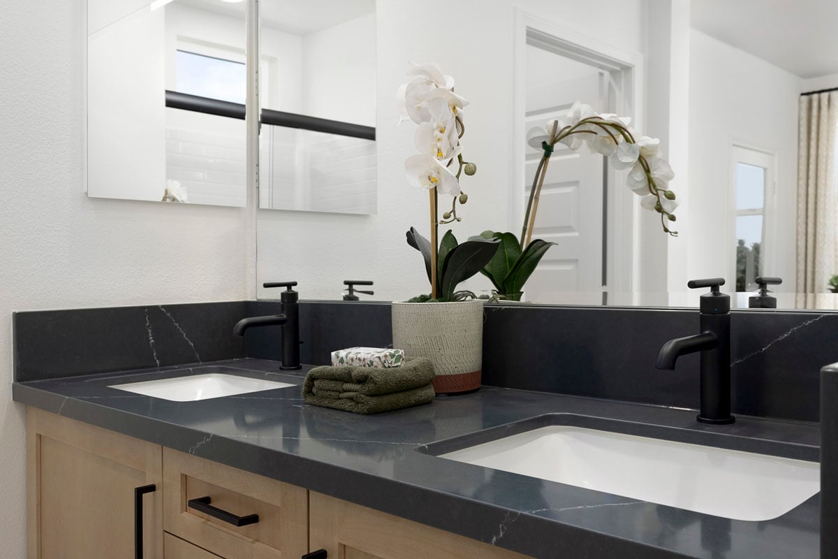 Optional quartz countertop and undermount sinks at primary bath