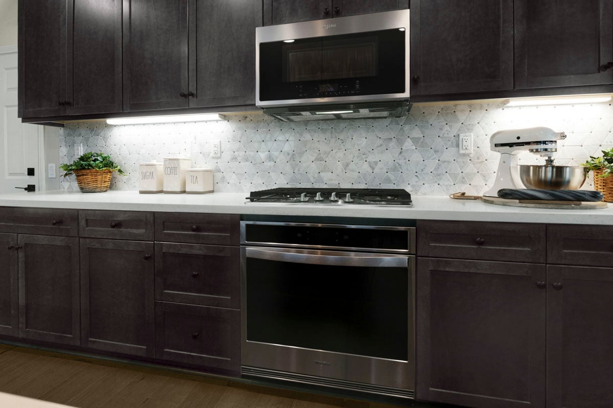 Upgraded maple cabinets with built-in oven and cooktop