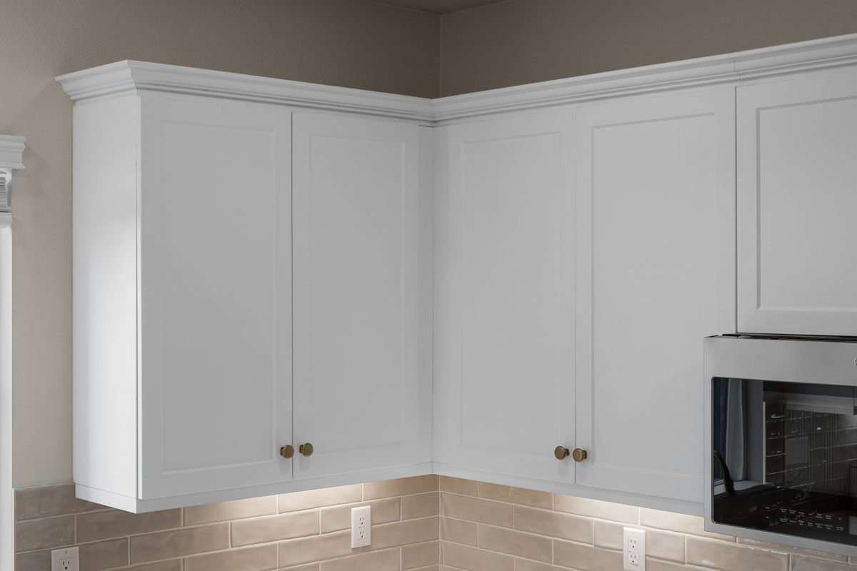 Upgraded Shaker door cabinets with gold knobs