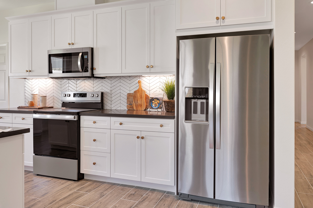 Upgraded Shaker-style cabinets with gold knobs