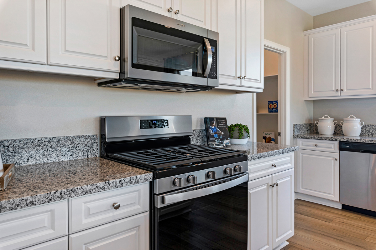 Granite kitchen countertops and white thermofoil cabinets