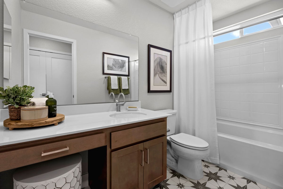 Extended vanity with maple cabinets and knee space at secondary bath