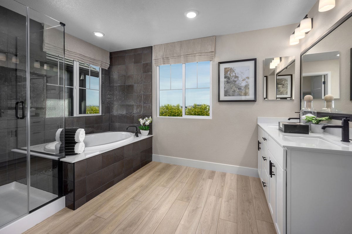 Tub and separate shower with tile surround at primary bath