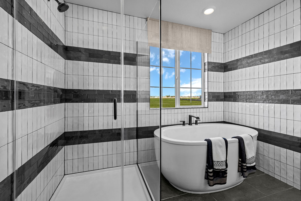 Tub and separate shower with custom tile surround at primary bath