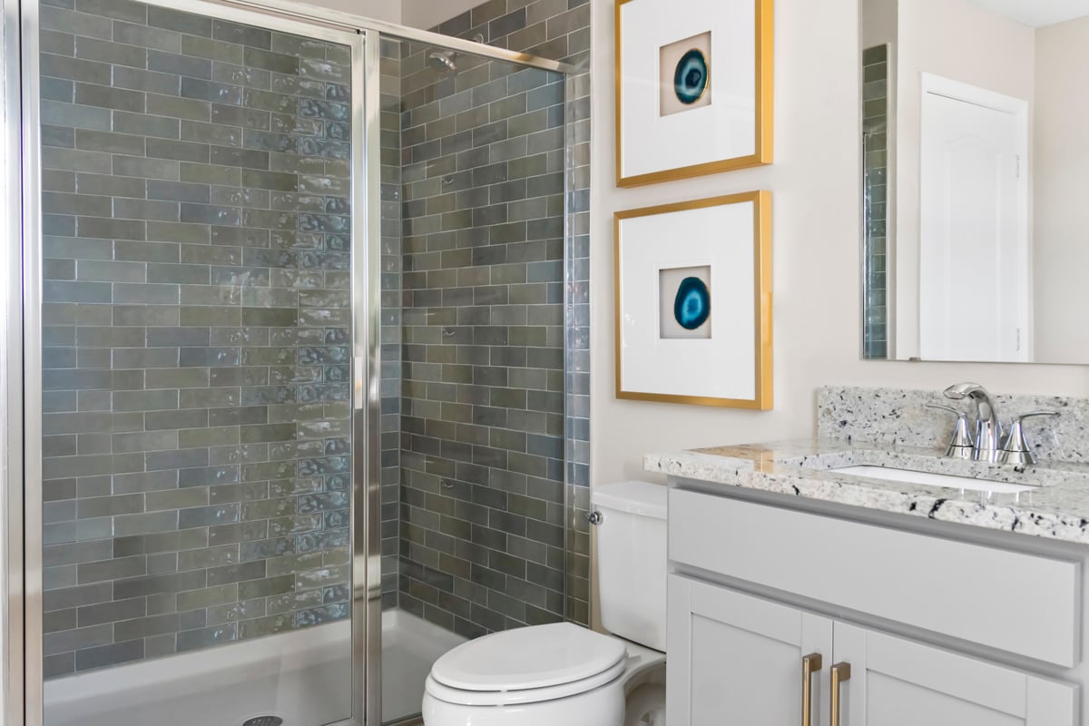 Walk-in shower with tile surround at primary bath