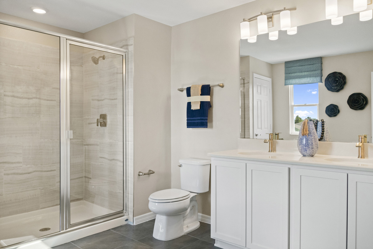 Walk-in shower with tile surround at primary bath