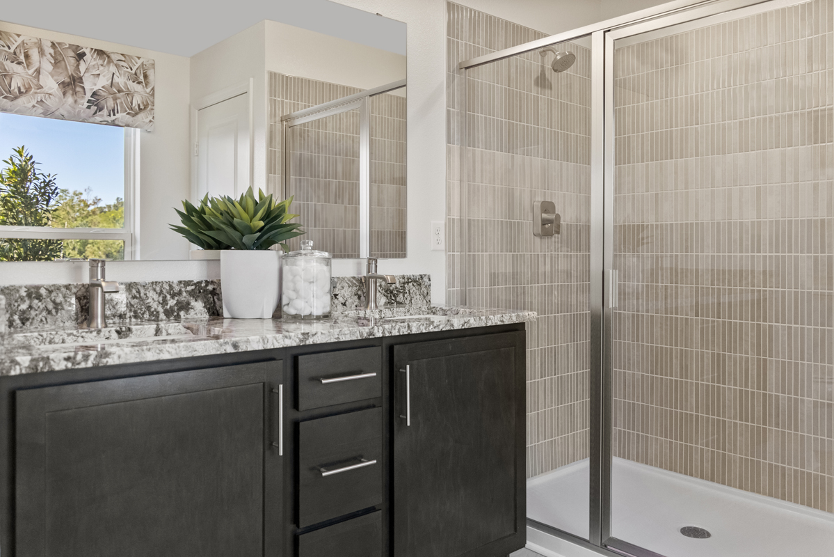 Walk-in shower with tile surround at primary bath