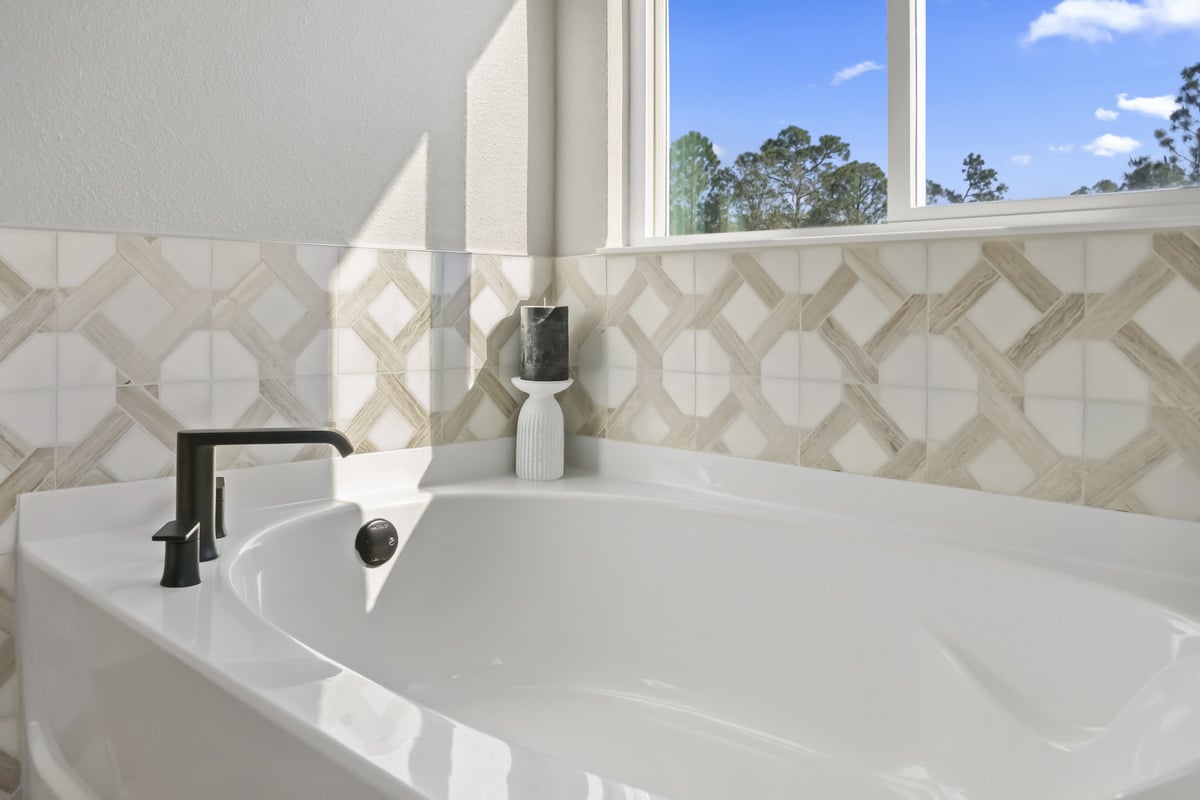 Garden tub with tile surround at primary bath