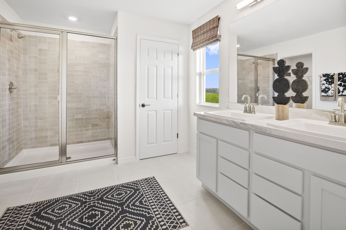 Walk-in shower with tile surround at primary bath