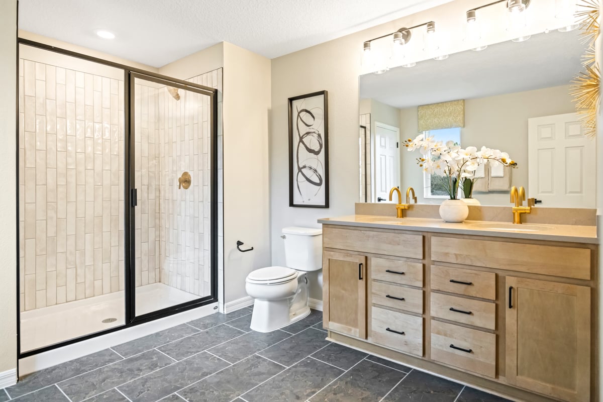 Walk-in shower with tile surround at primary bath