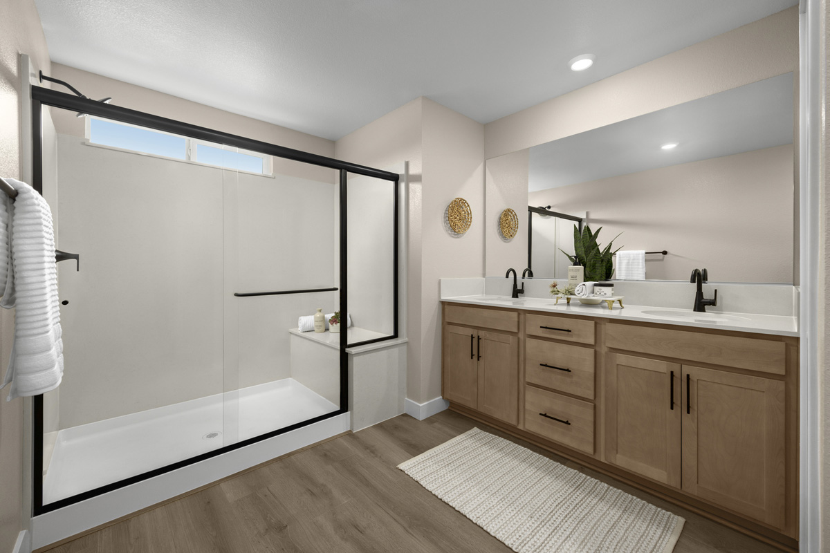 Enlarged walk-in shower with seat at primary bath