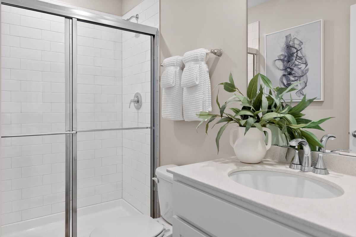 Walk-in shower with tile surround at primary bath