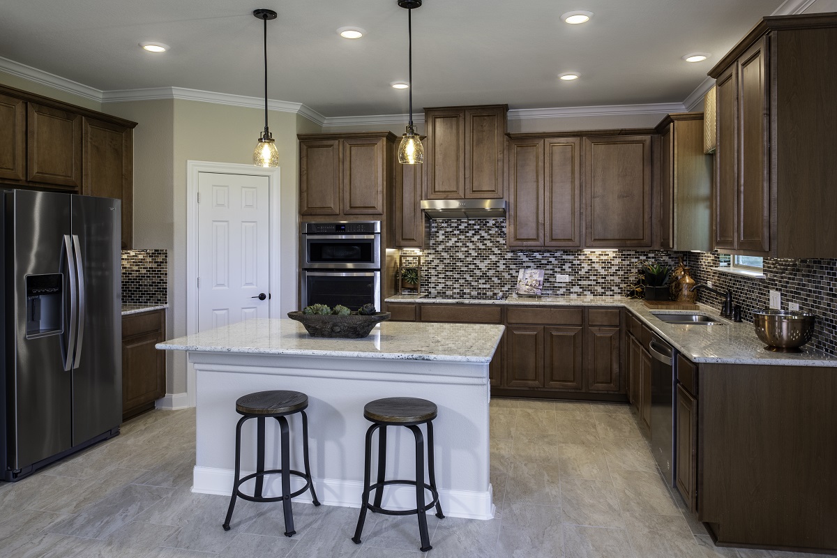 New Homes in Austin, TX - McKinney Crossing Plan 2655 Kitchen as modeled at Stagecoach Crossing