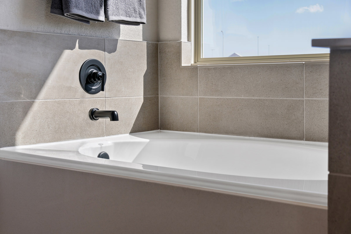 Garden tub with tile surround at primary bath