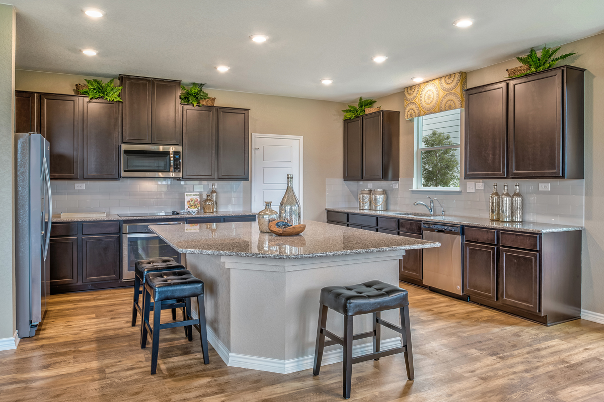 New Homes in Seguin, TX - Woodside Farms Plan 2897 Kitchen as modeled at Falcon Landing