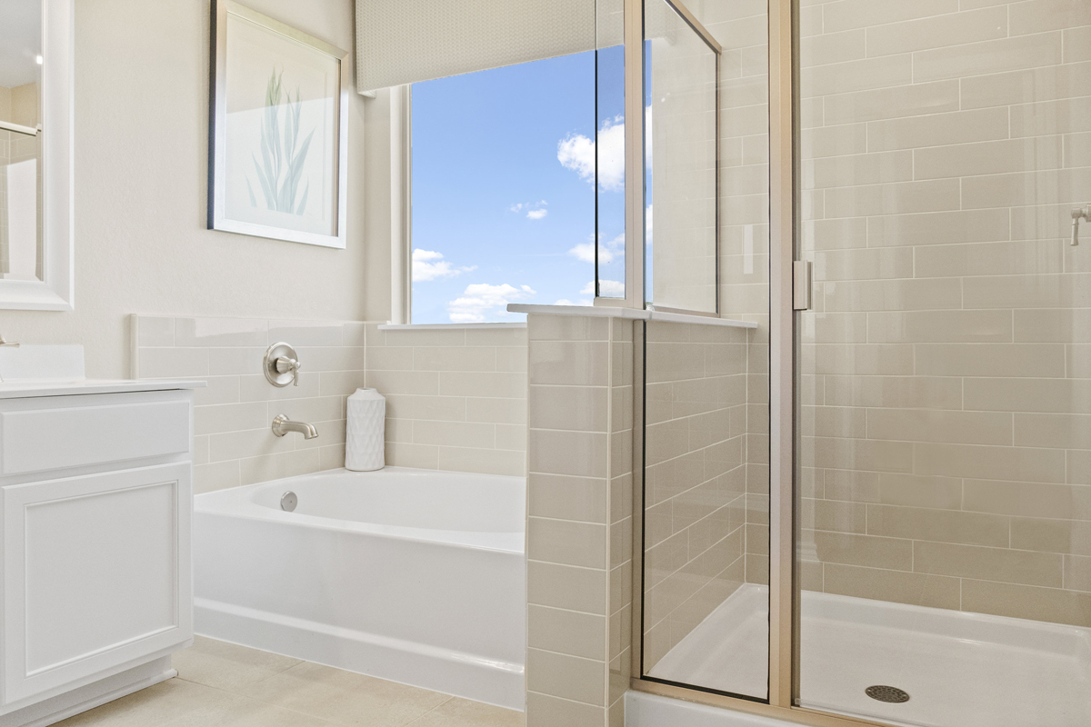 Garden tub and separate shower with tile surround at bath