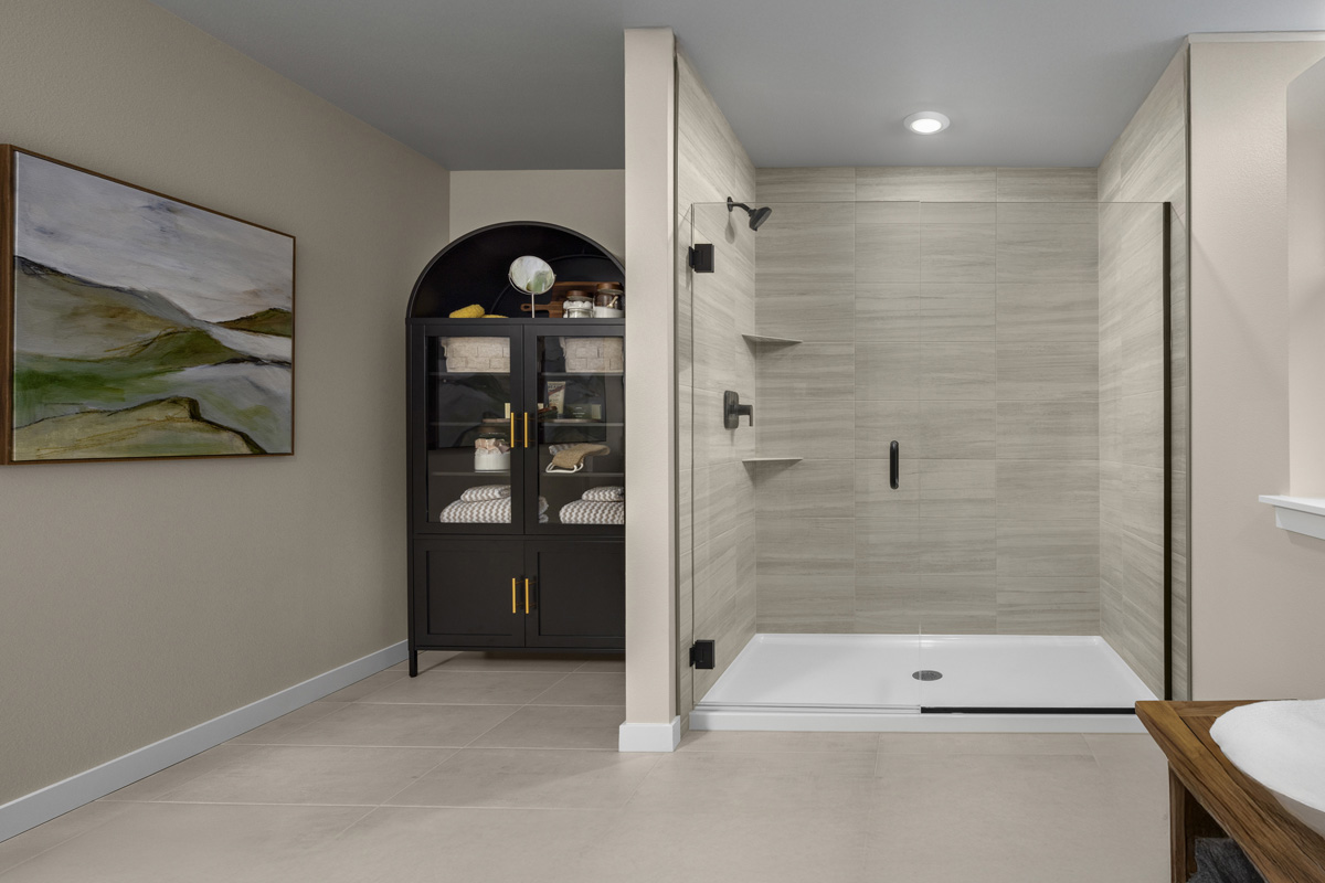 Walk-in shower with glass enclosure at primary bath